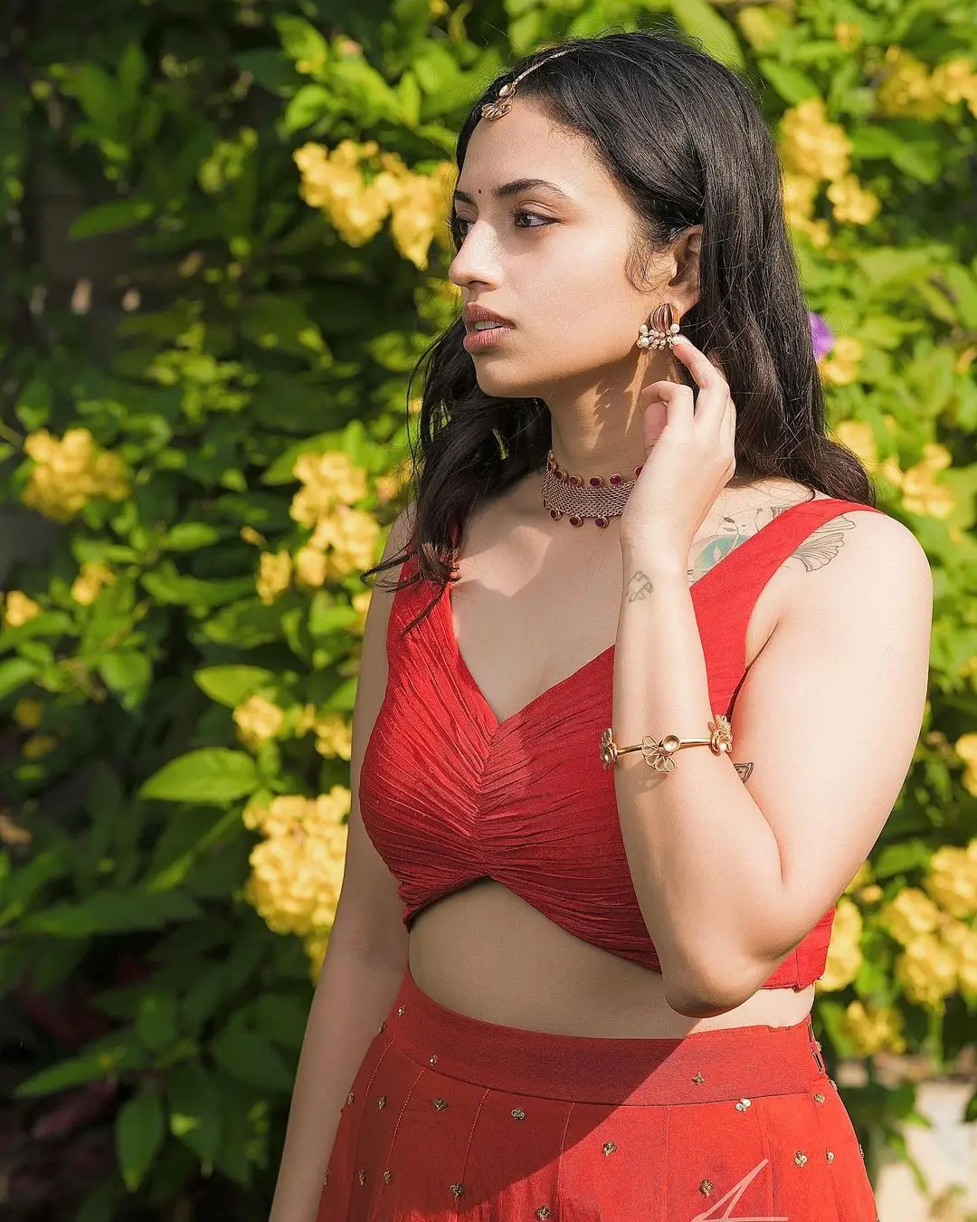 malvika nair in sleeveless red lehenga choli